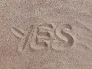 qualify for factoring blog feature image - word yes written in sand