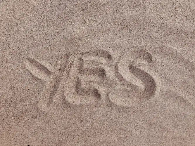 qualify for factoring blog feature image - word yes written in sand