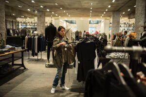 lady shopping for apparel with mask on in retail store